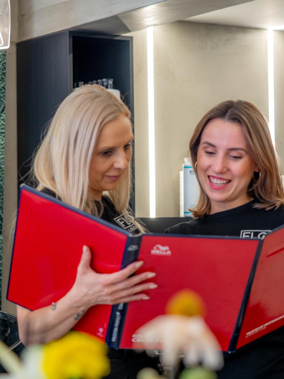 Flo London colourists selecting a shade from the colour chart